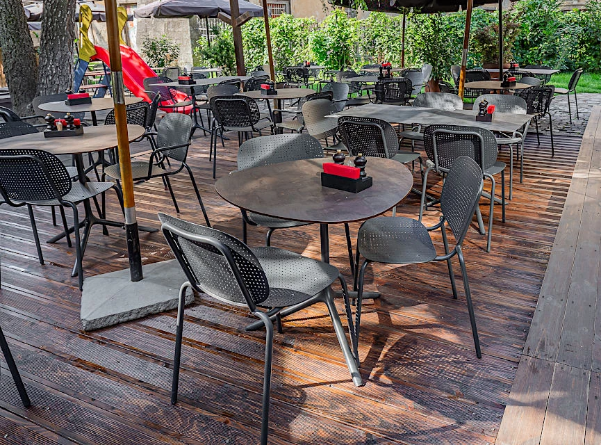 Вуличні столи різних геометричних форм на терасі ресторану