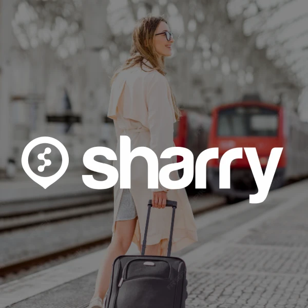 logo i nazwa firmy Sharry na tle dziewczyny, która idzie obok pociągu