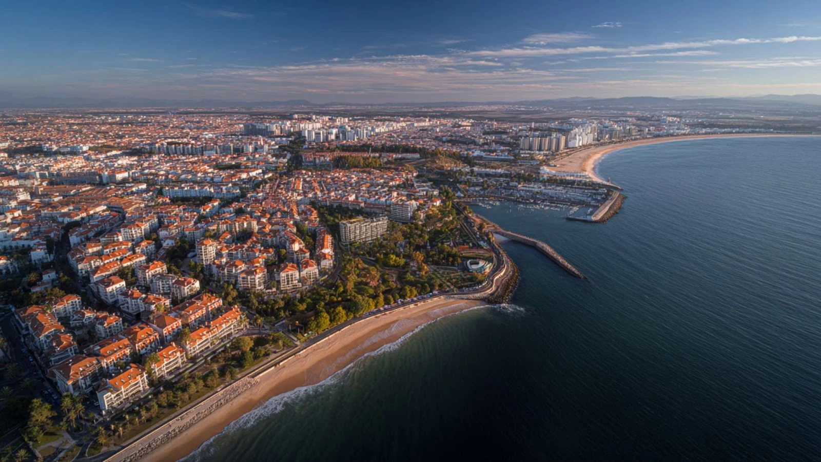 Panoramic view of Portugal’s coastline with modern commercial buildings, highlighting investment appeal for those looking to buy property in Portugal.