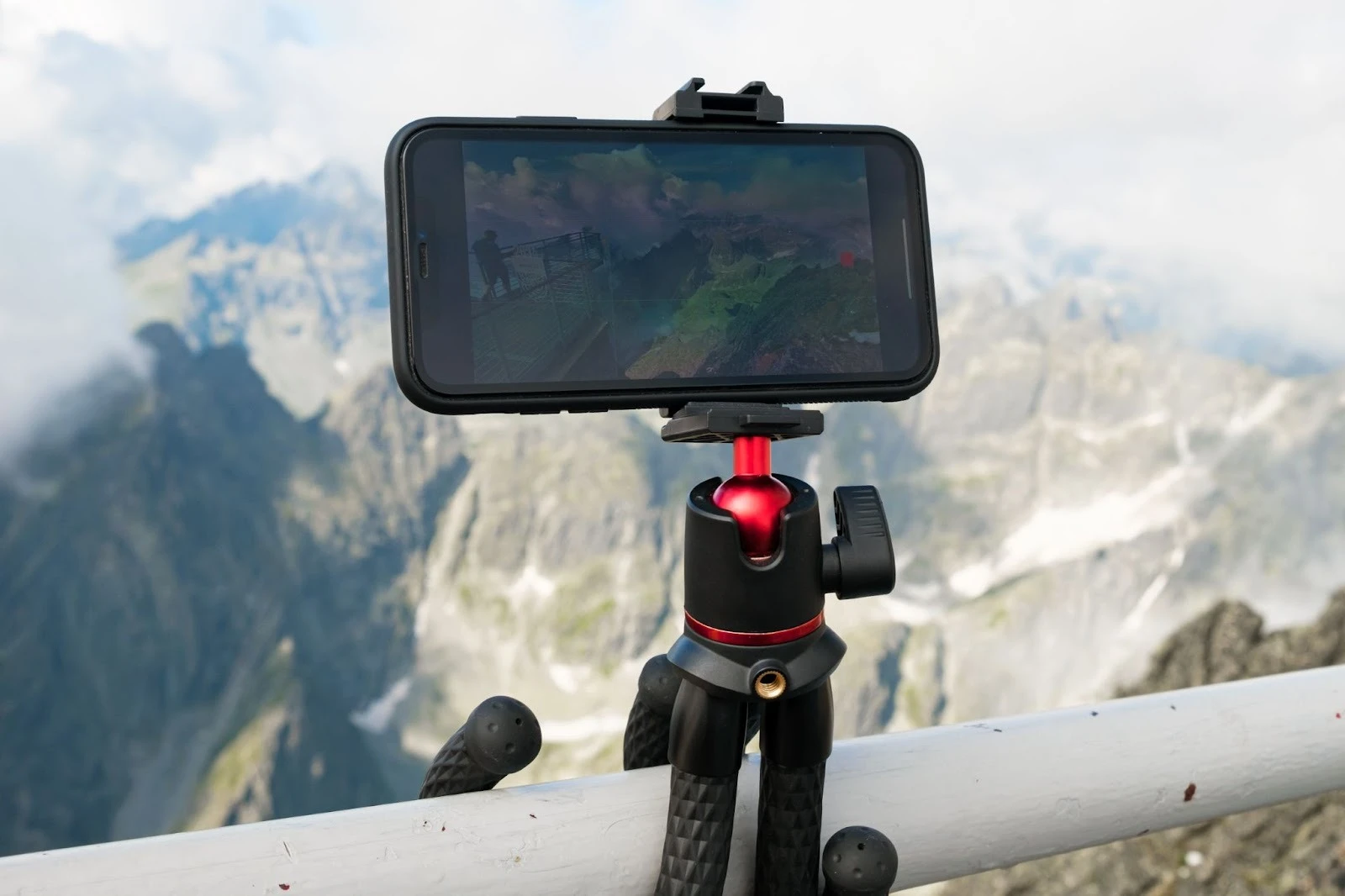 Phone on a rail recording a video on the mountain