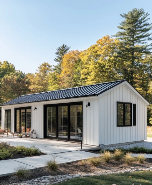Modern fire-resistant home with metal roof and non-combustible siding surrounded by defensible landscaping.
