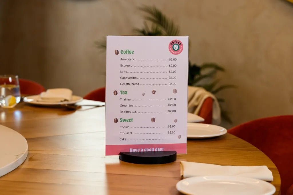 wooden and acrylic table stands holding QR codes and promotional cards in a modern café