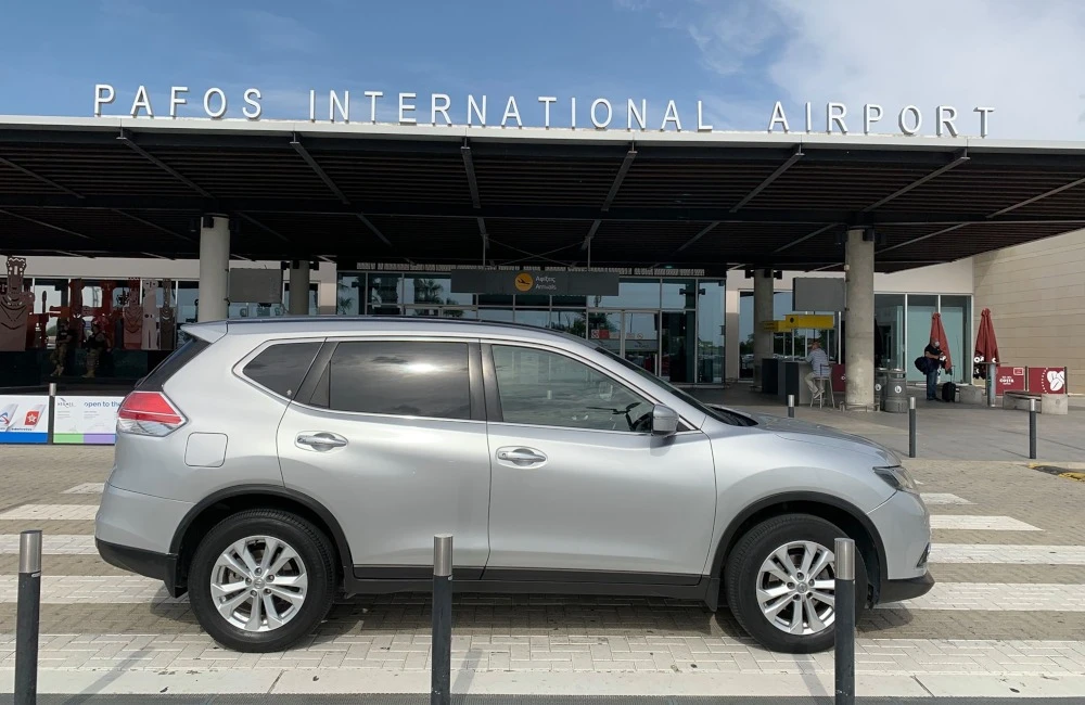 A car parked in front of the Pafos Airport
