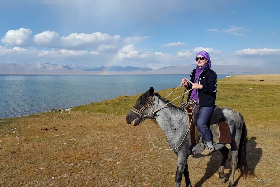 woman is driving horse in kyrgyzstan