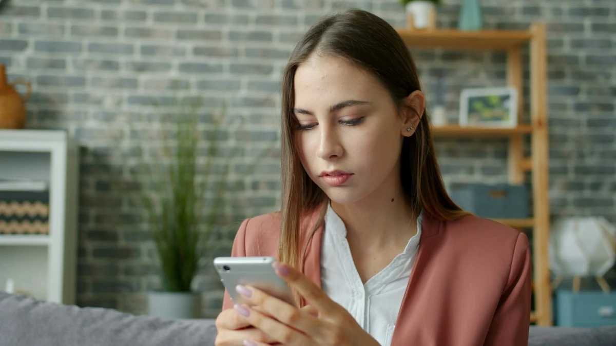 confident businesswoman using smartphone