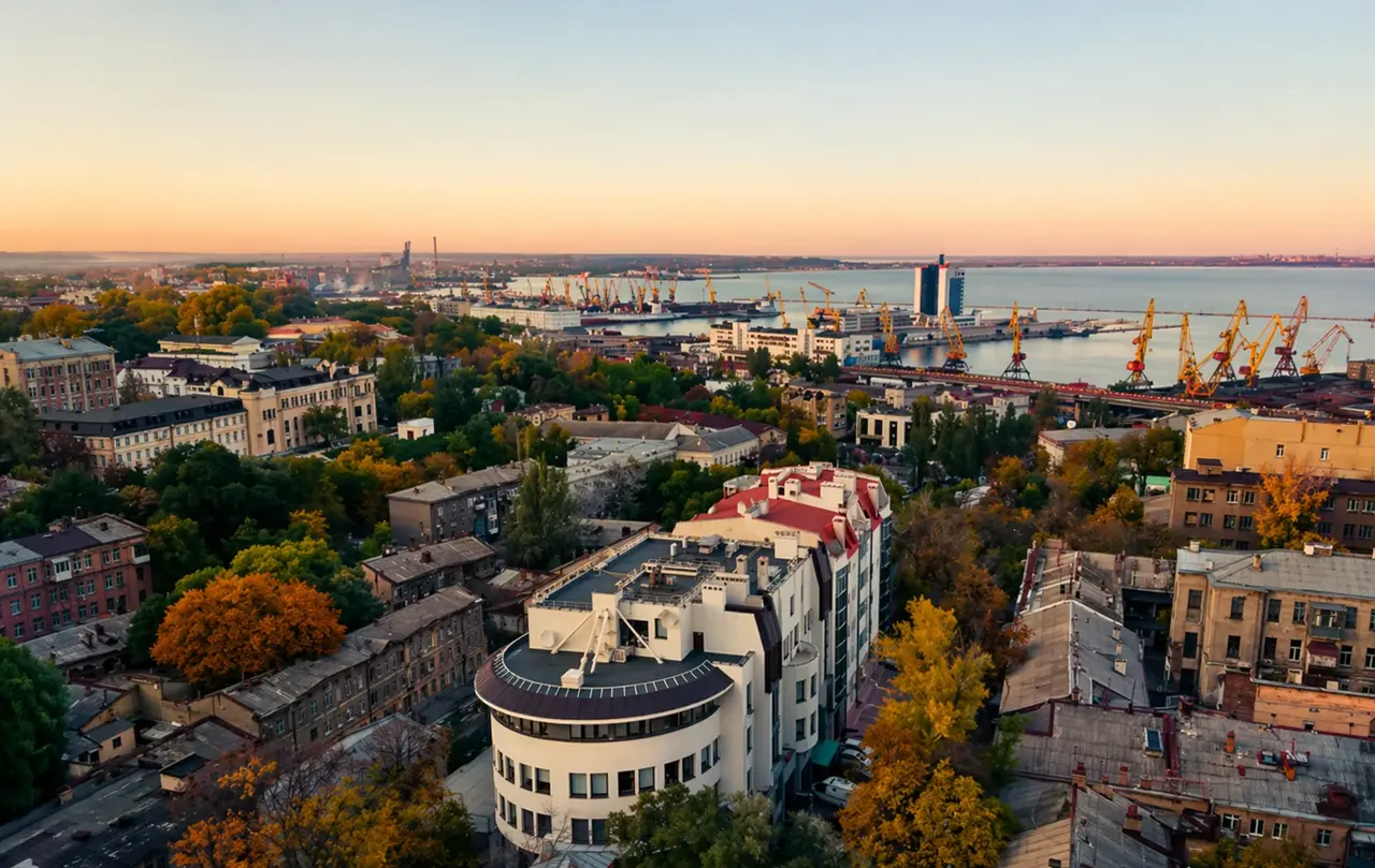 Панорама історичного центру Одеси з видом на порт і море на заході сонця — щільна забудова, поєднання старих будинків і нових об’єктів у найліквіднішій локації міста 2026 року.