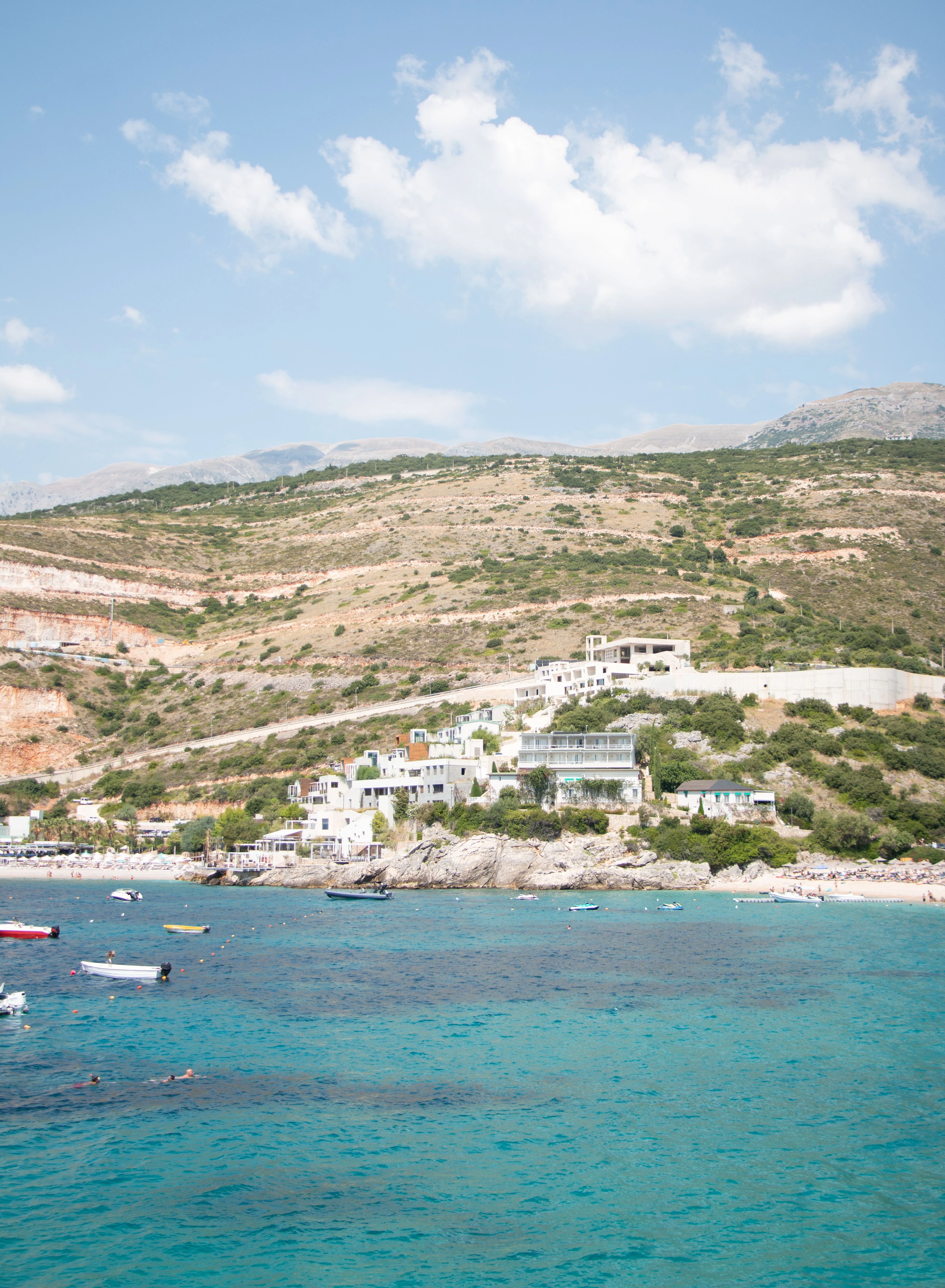 Aerial view of a coastal village and turquoise sea on the Albanian Riviera