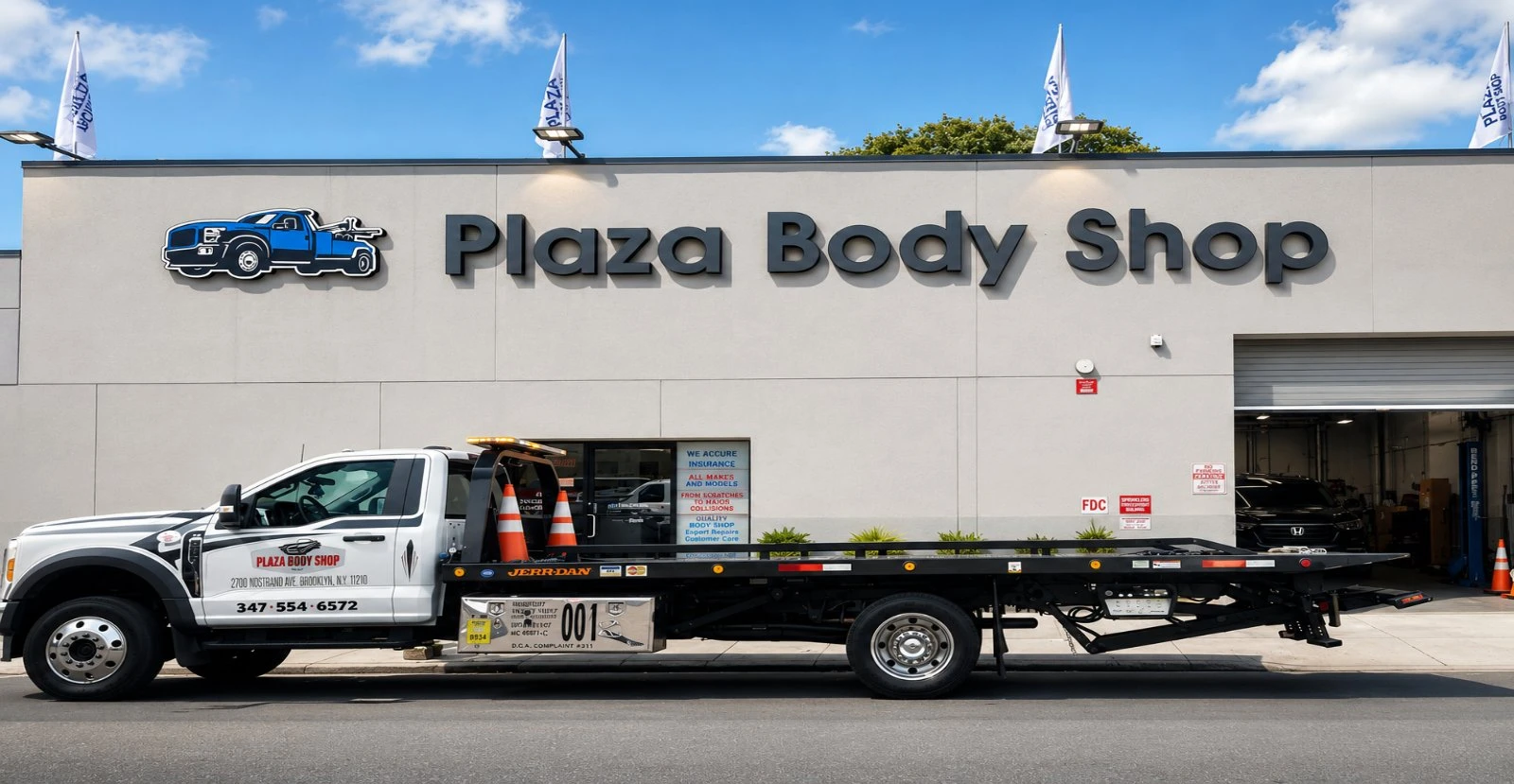 Plaza Body Shop flatbed tow truck parked outside the shop on Nostrand Avenue in Brooklyn, NY