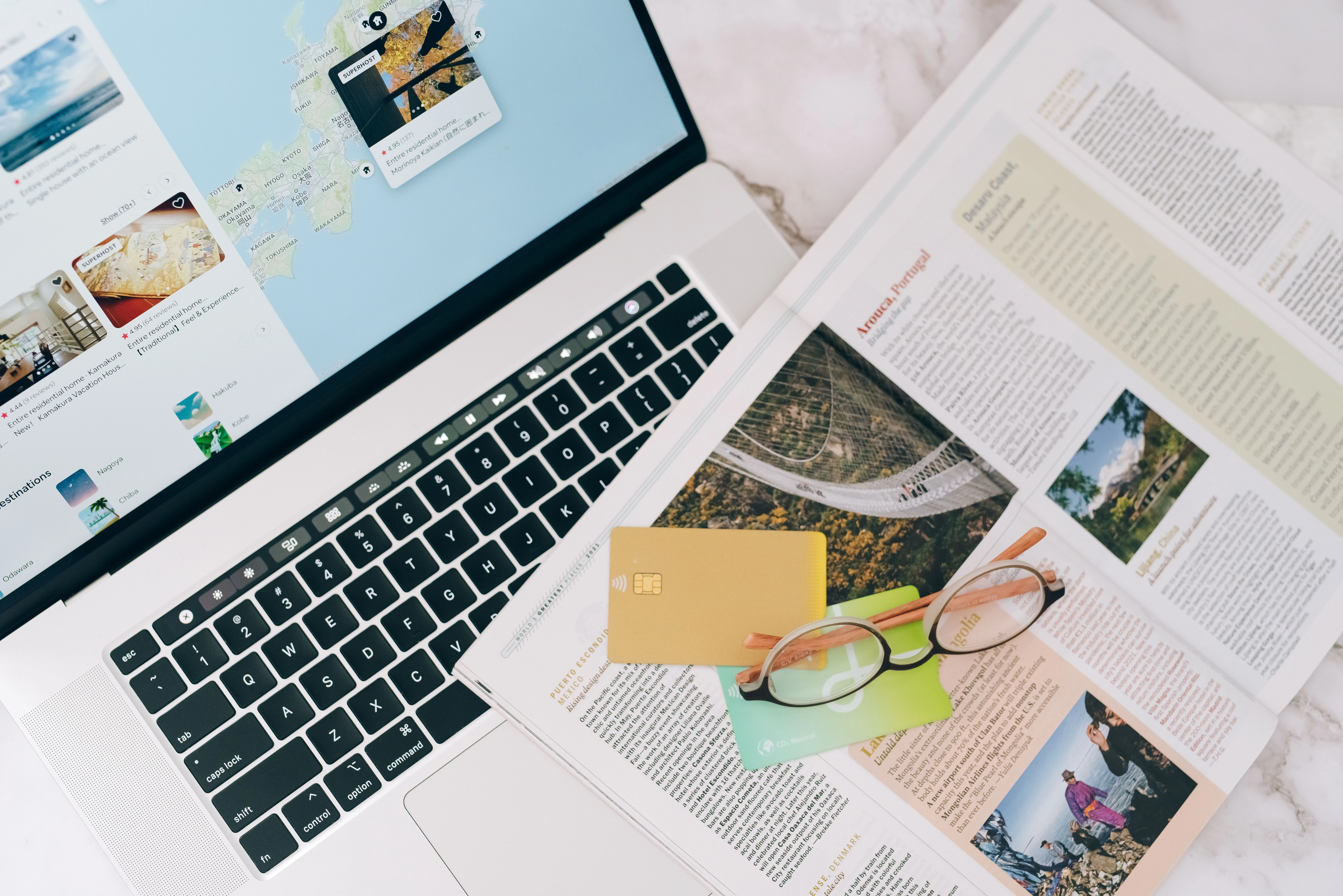 Travel money planning with credit cards, laptop and map