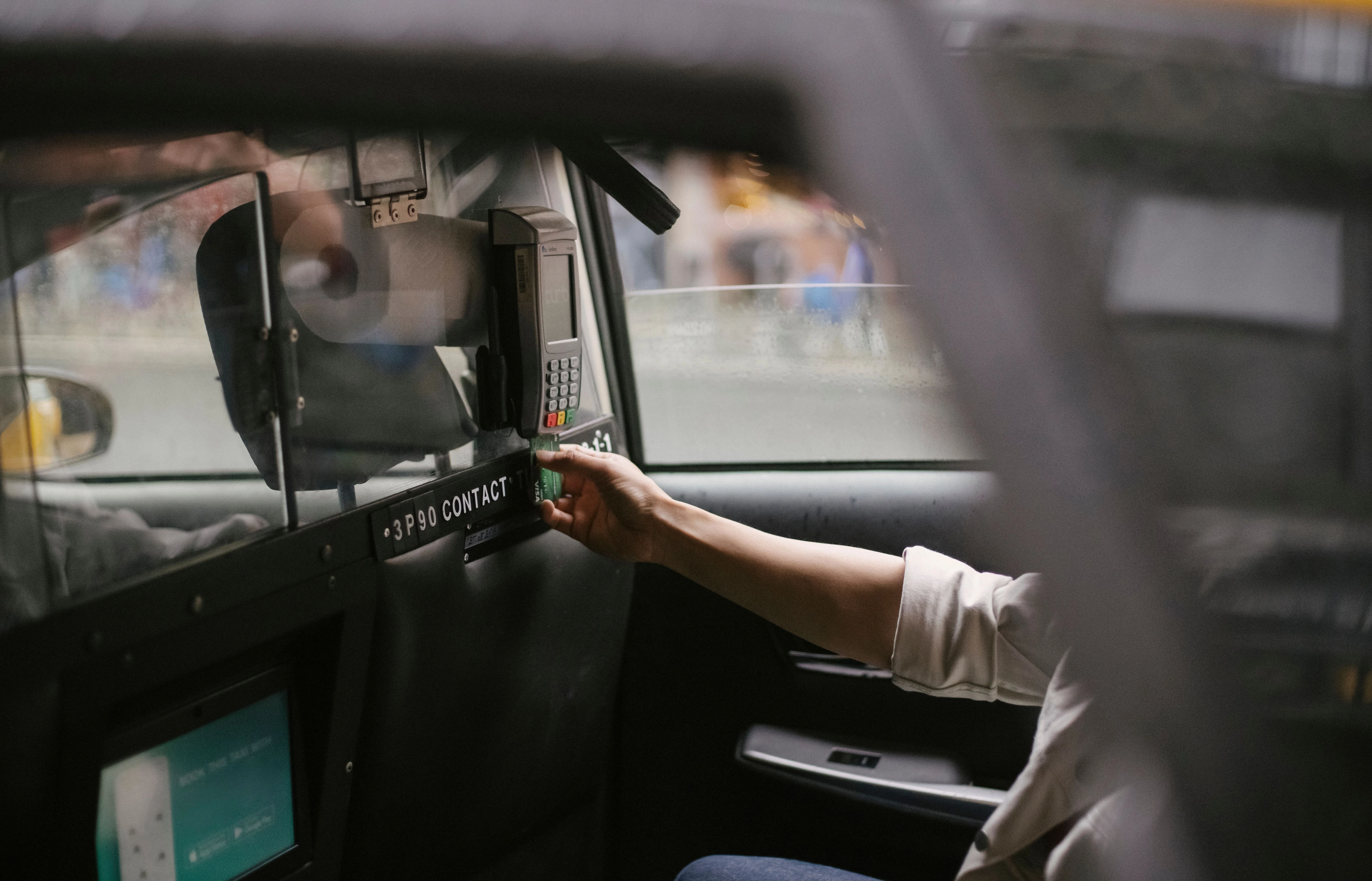 Traveler paying for a taxi by credit card