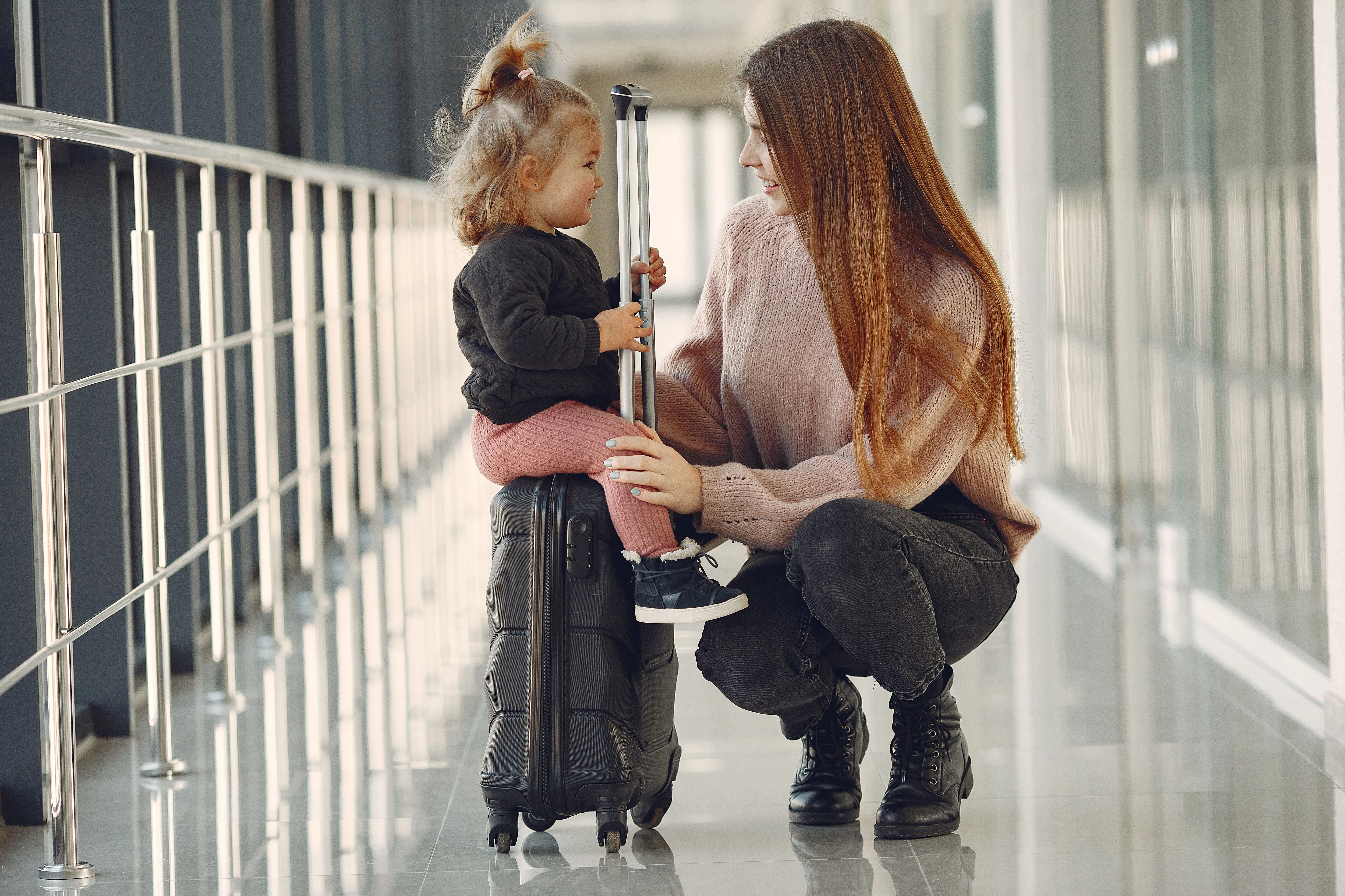 Mother and daughter traveling together at an airport