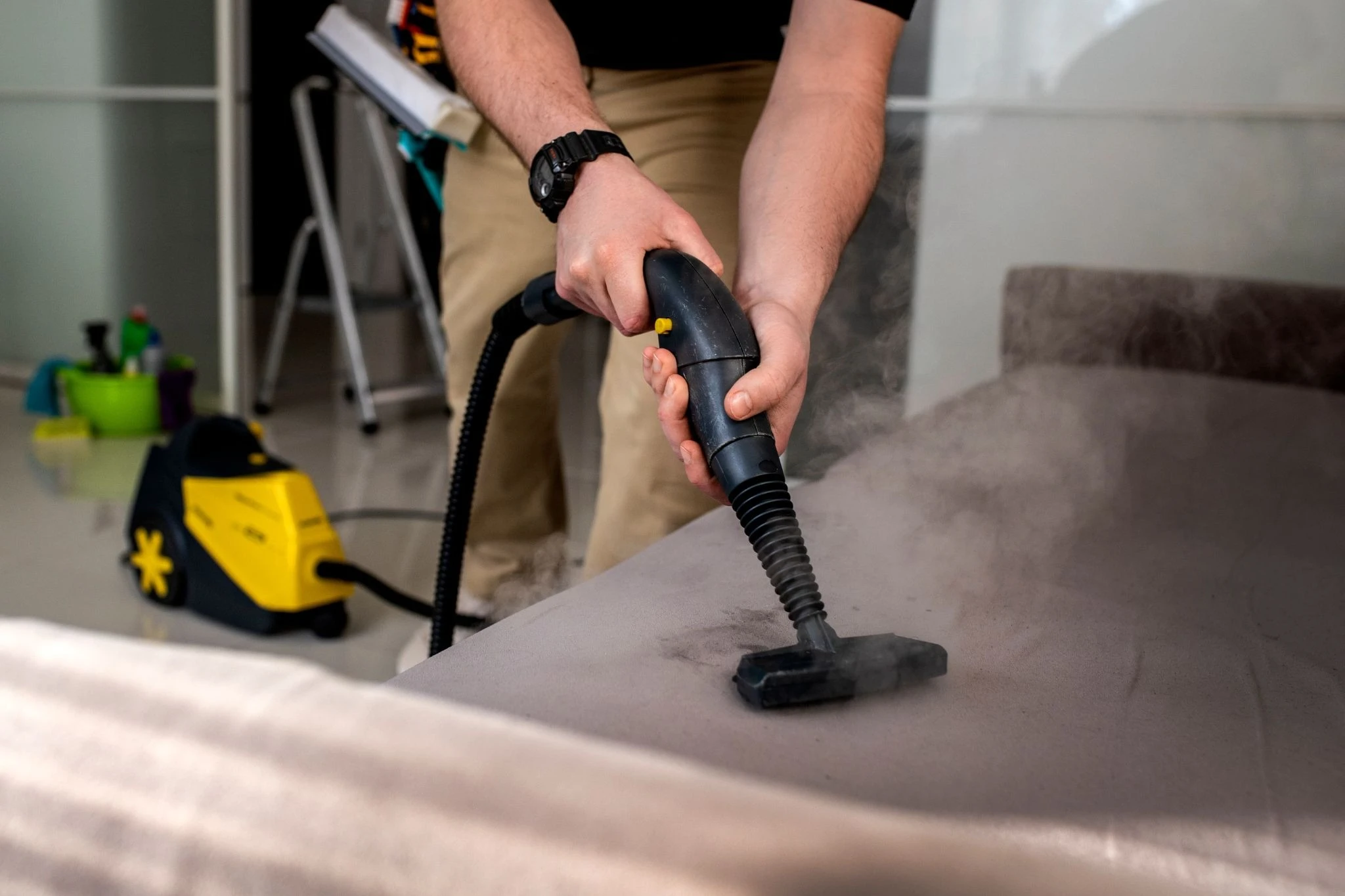 Professional couch cleaning with a steam extractor.