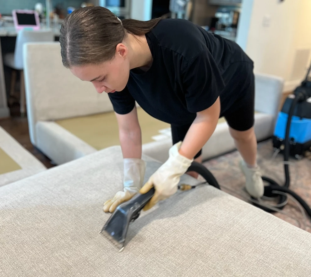 Couch Steamers technician deep-cleaning a sofa with water extraction.