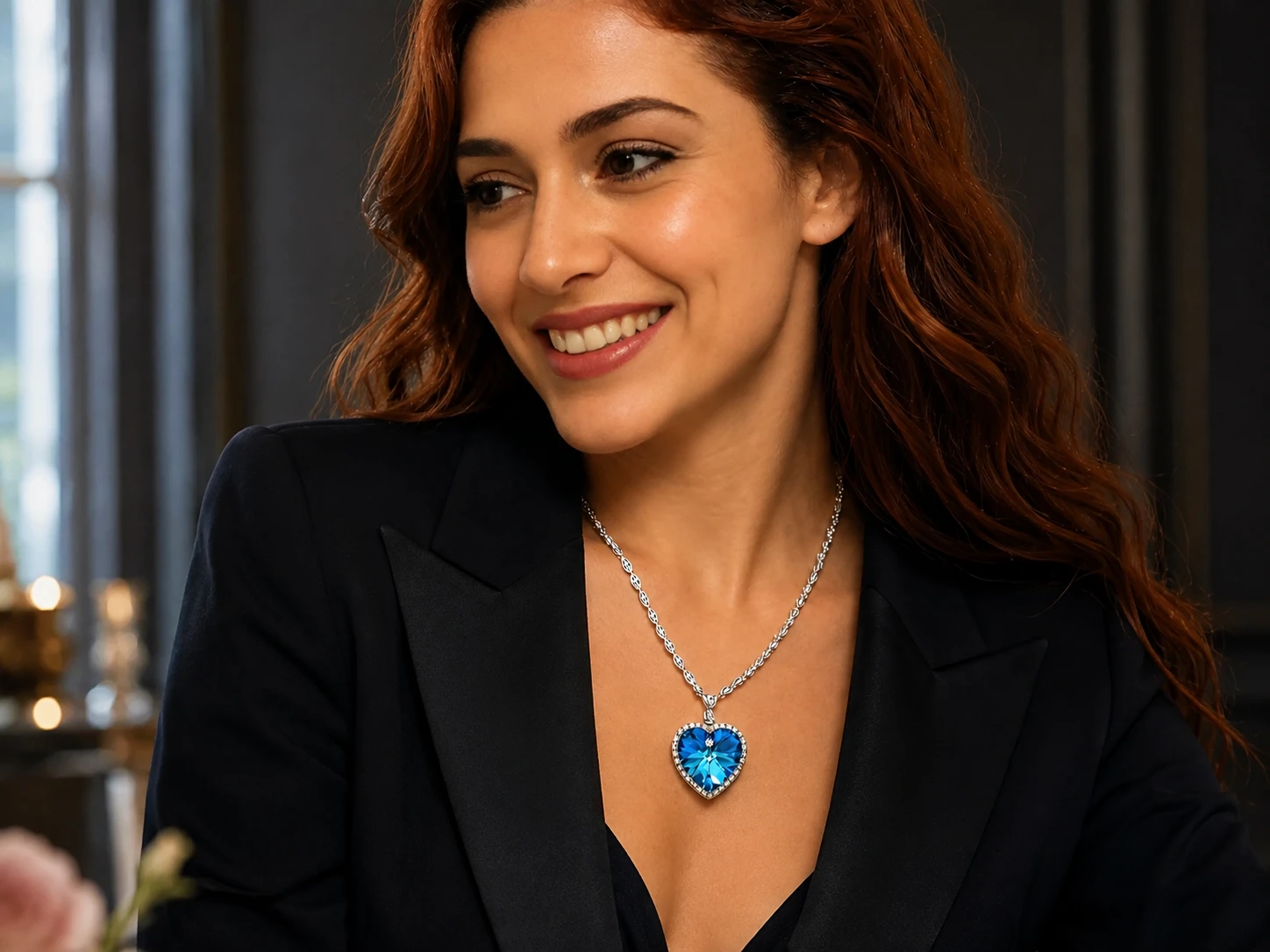 Woman wearing a contemporary Heart of the Ocean blue heart necklace