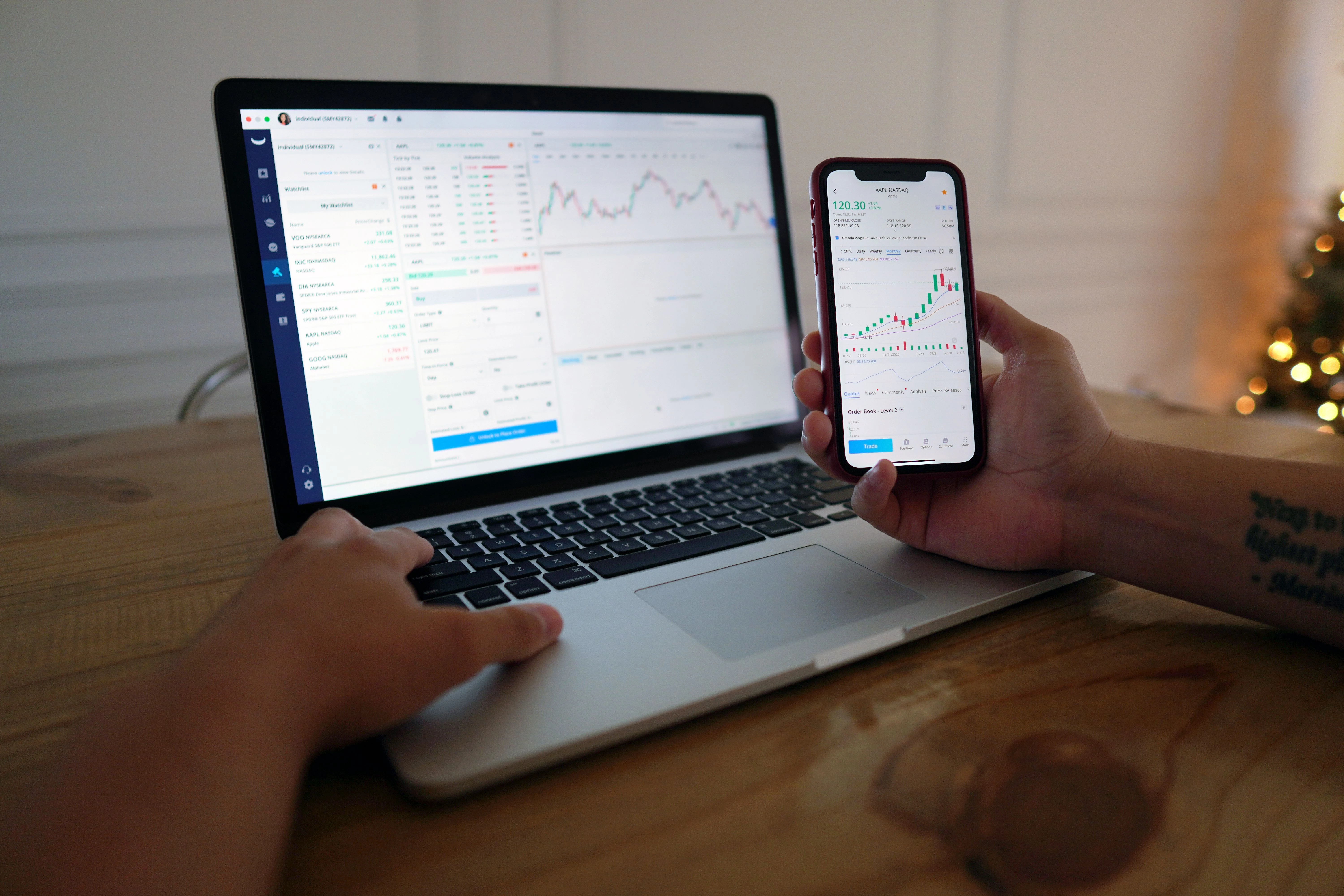 Trader monitoring forex market conditions on laptop and smartphone