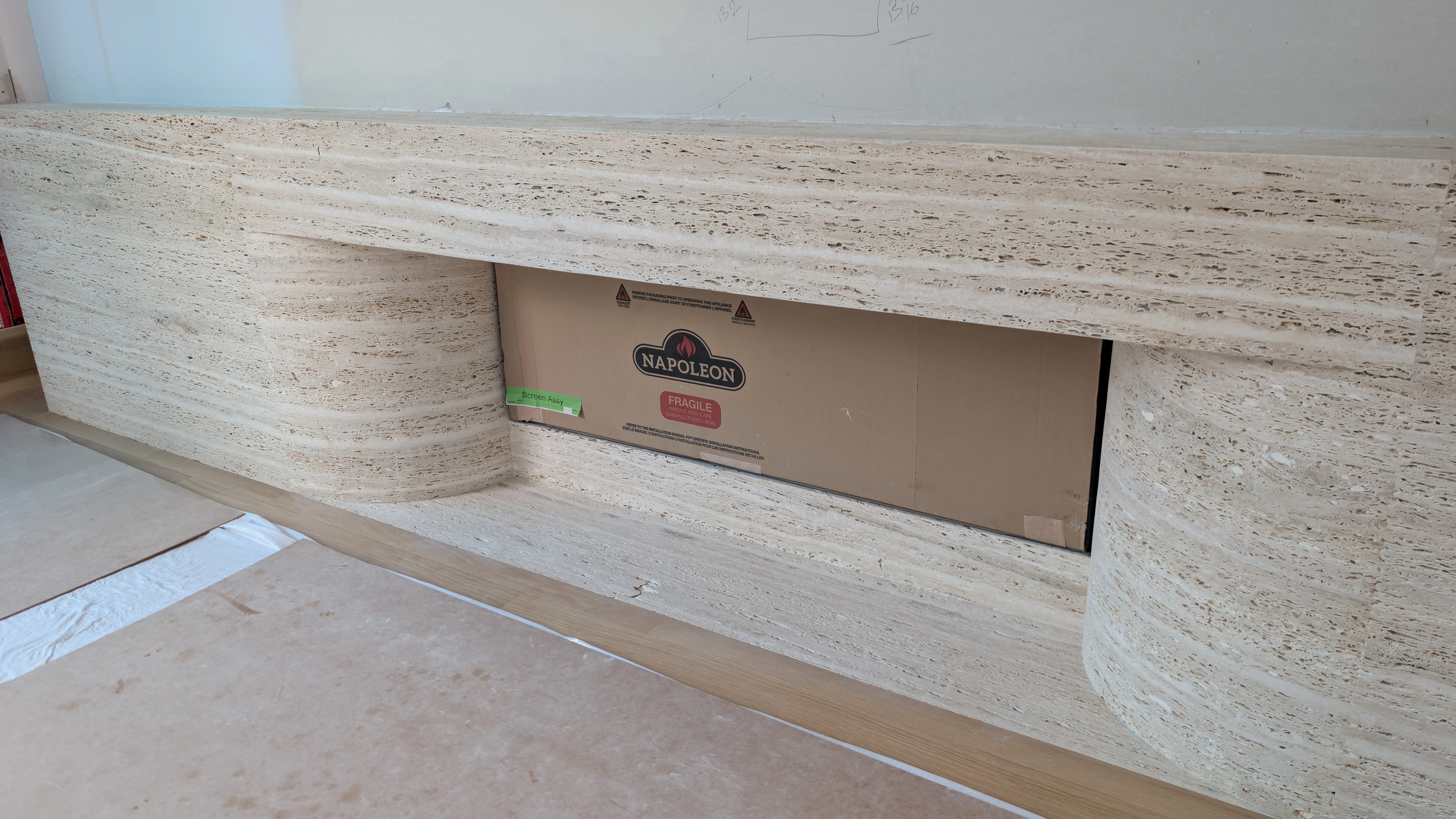Floor-to-ceiling stone fireplace wall with natural veining